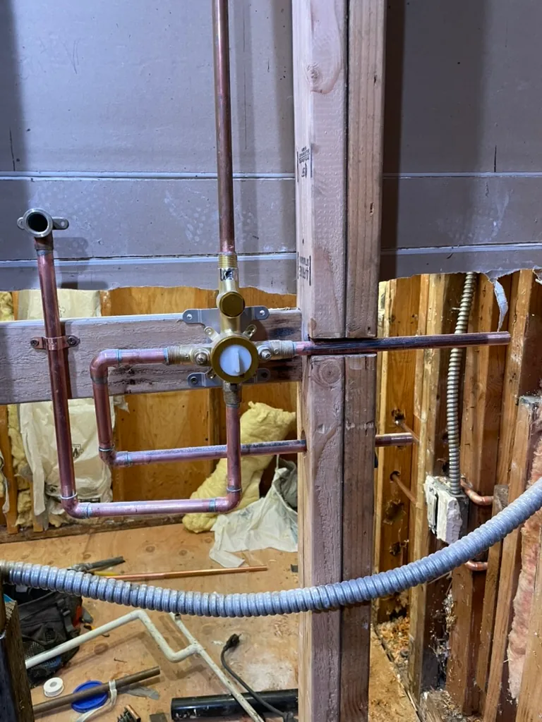 A new shower valve with new copper supply lines in the open wall