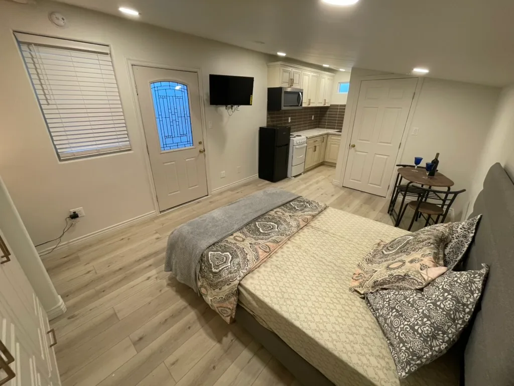 The finished unit with its entry door, the kitchen at the far end and the bedroom area in front