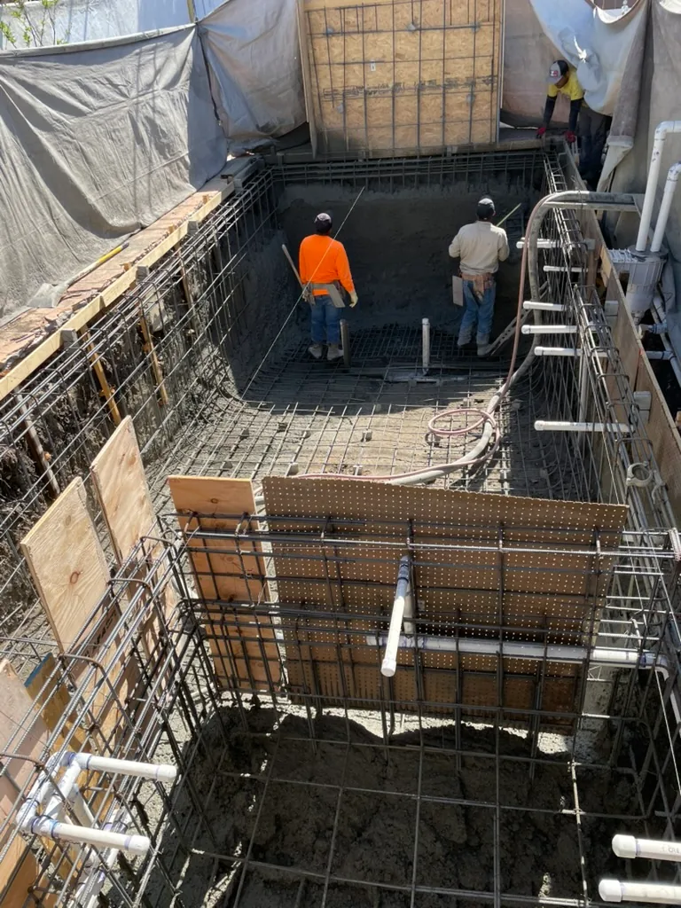 Shotcrete on the far walls of the shell, with the spa rebar and forms in the foreground