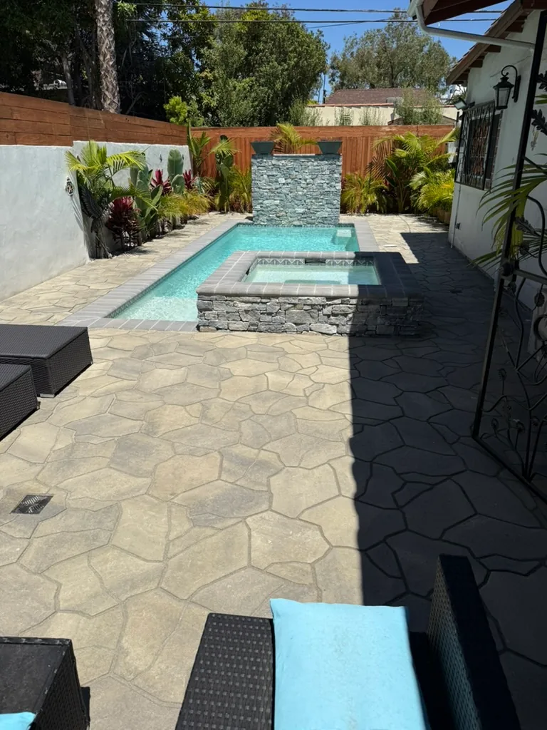 The finished yard with planting along the wall, seen from the house end