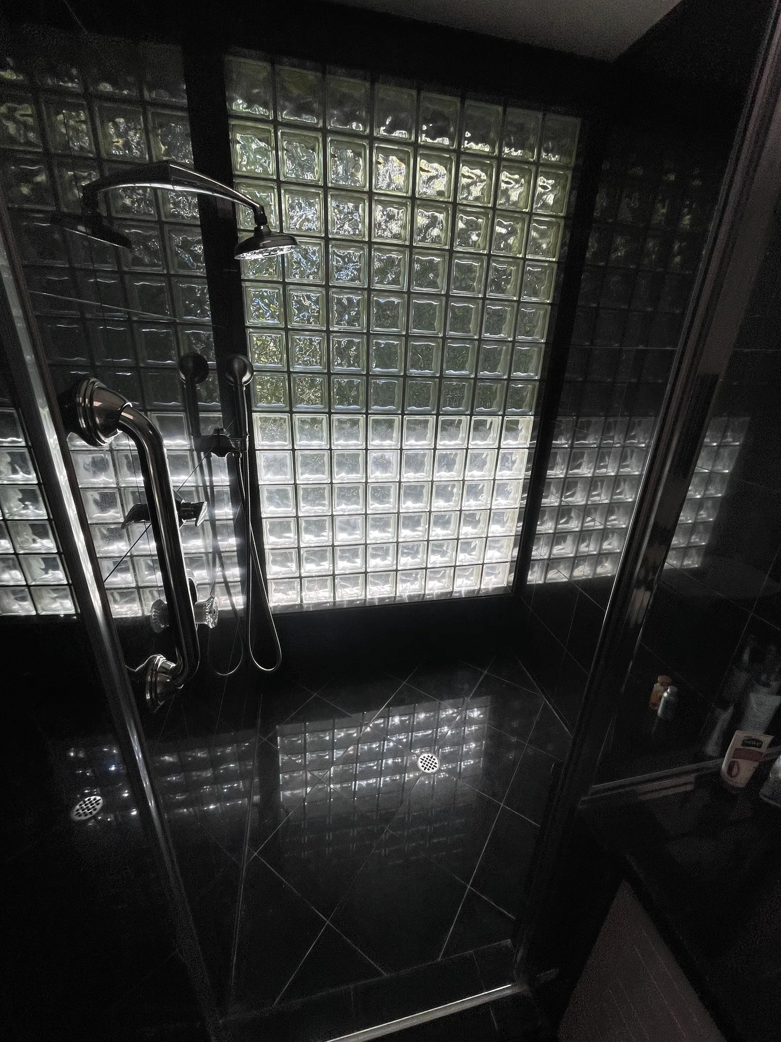 The inside of a glass block shower window on the second floor