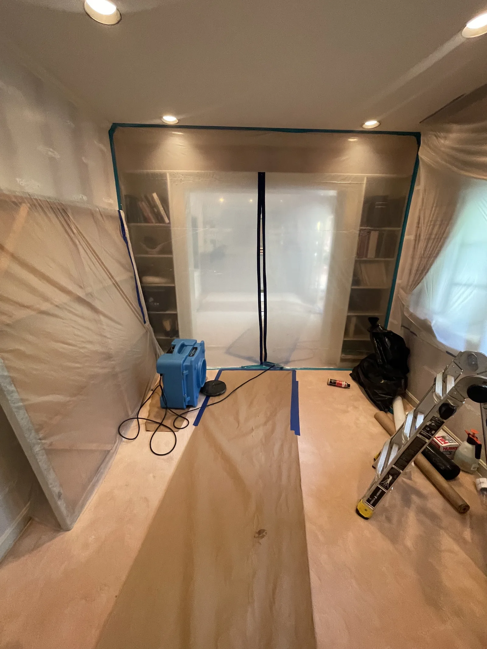 A room sealed off with plastic sheeting and a dehumidifier running