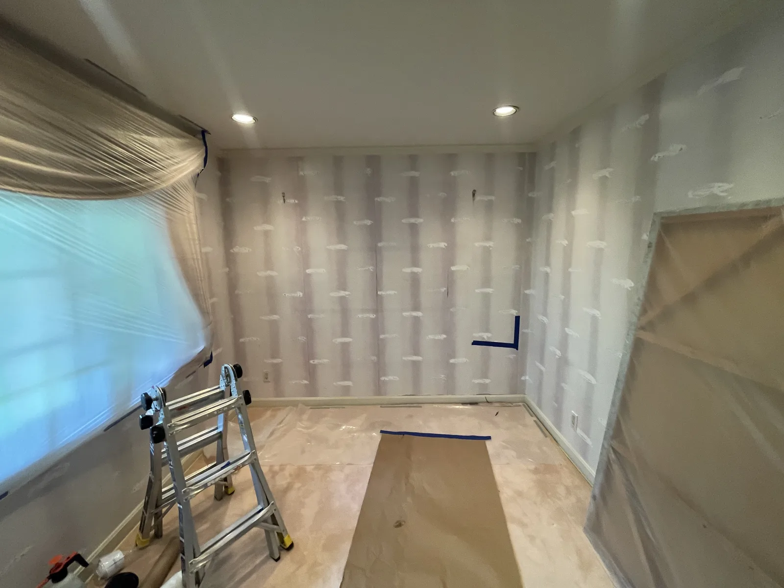 A room lined with plastic sheeting over the walls