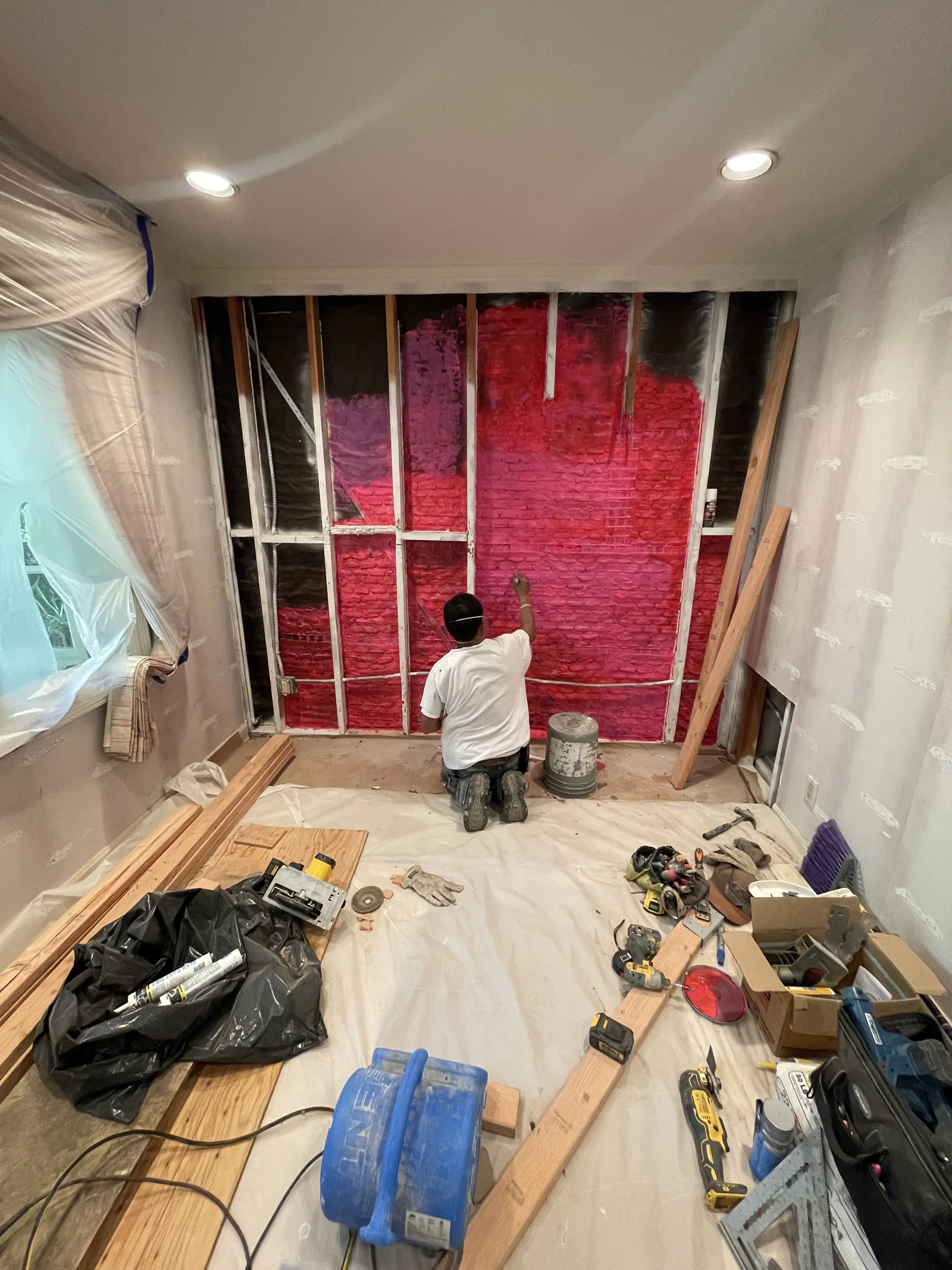 New wall framing with a weather-resistive barrier and metal ties installed
