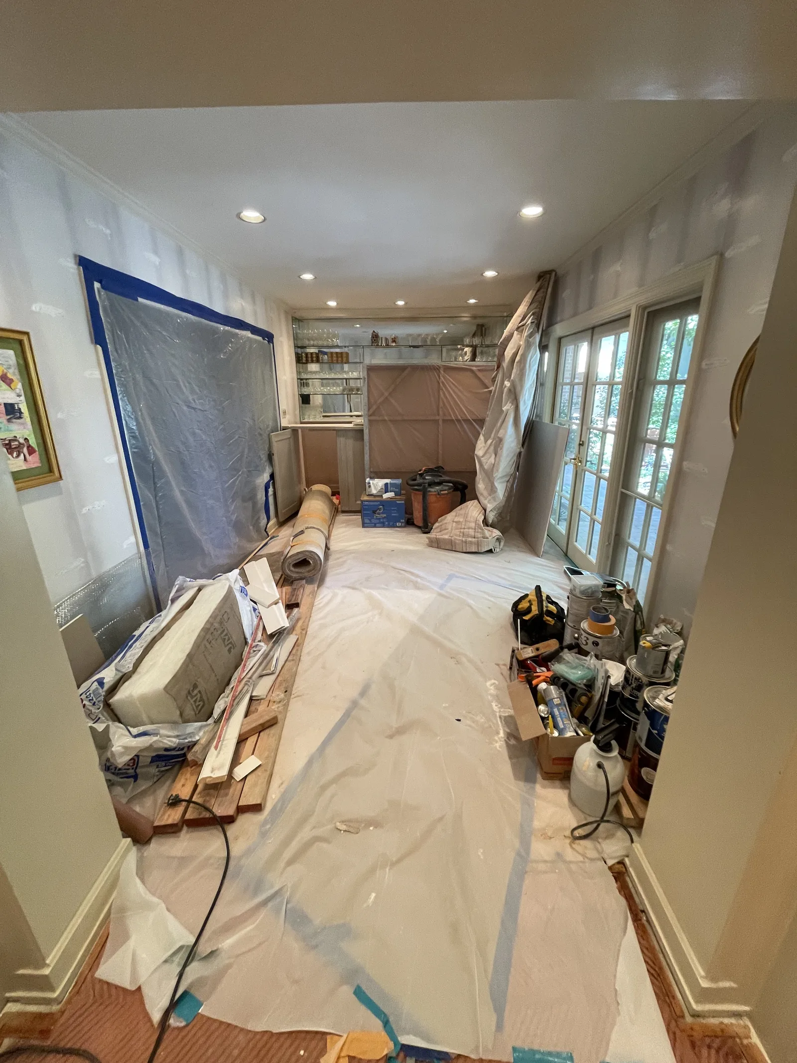 A room during painting, with part of a wall masked off