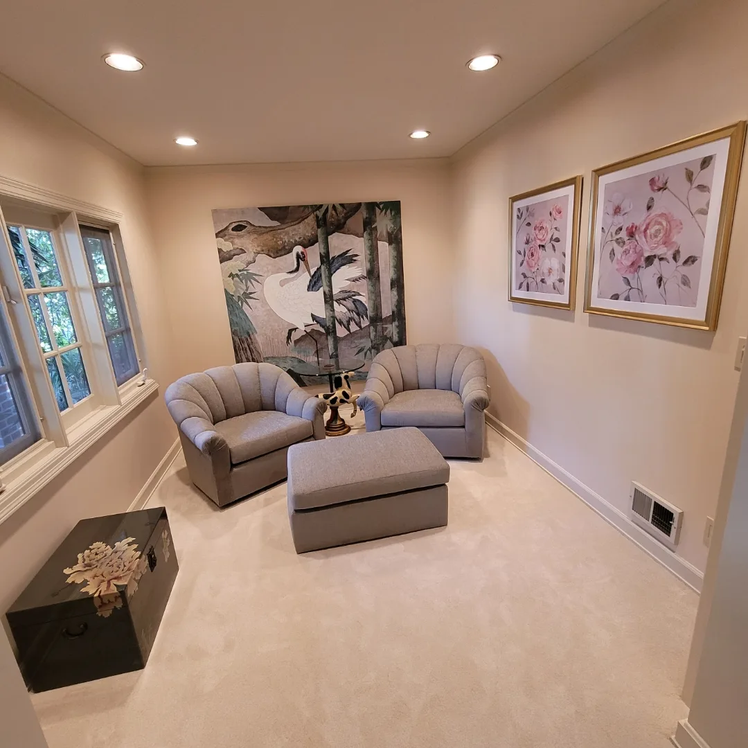 The finished room with new paint, the wallpaper removed, and furniture in place