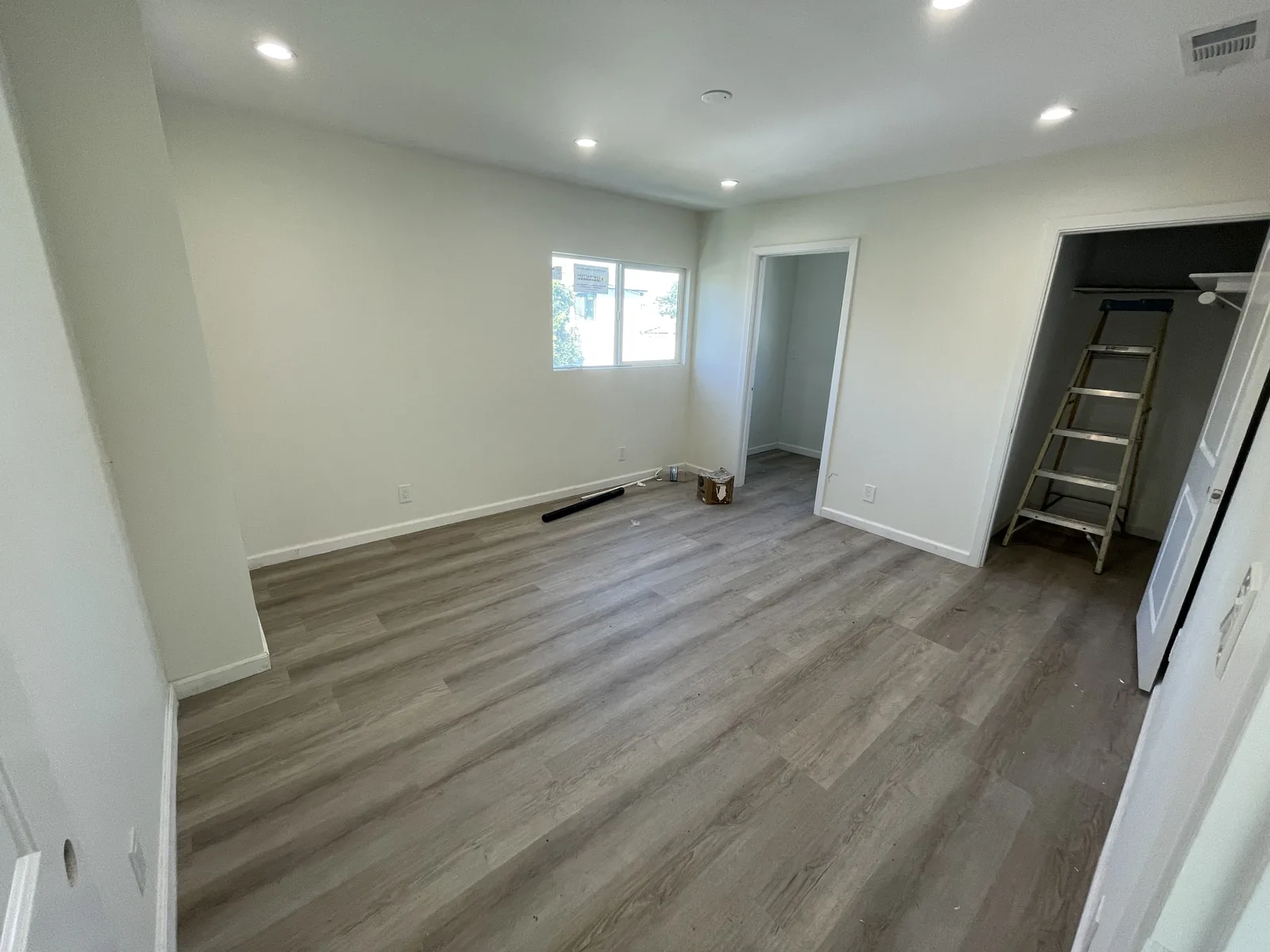 A near-finished second-floor bedroom with a walk-in closet visible