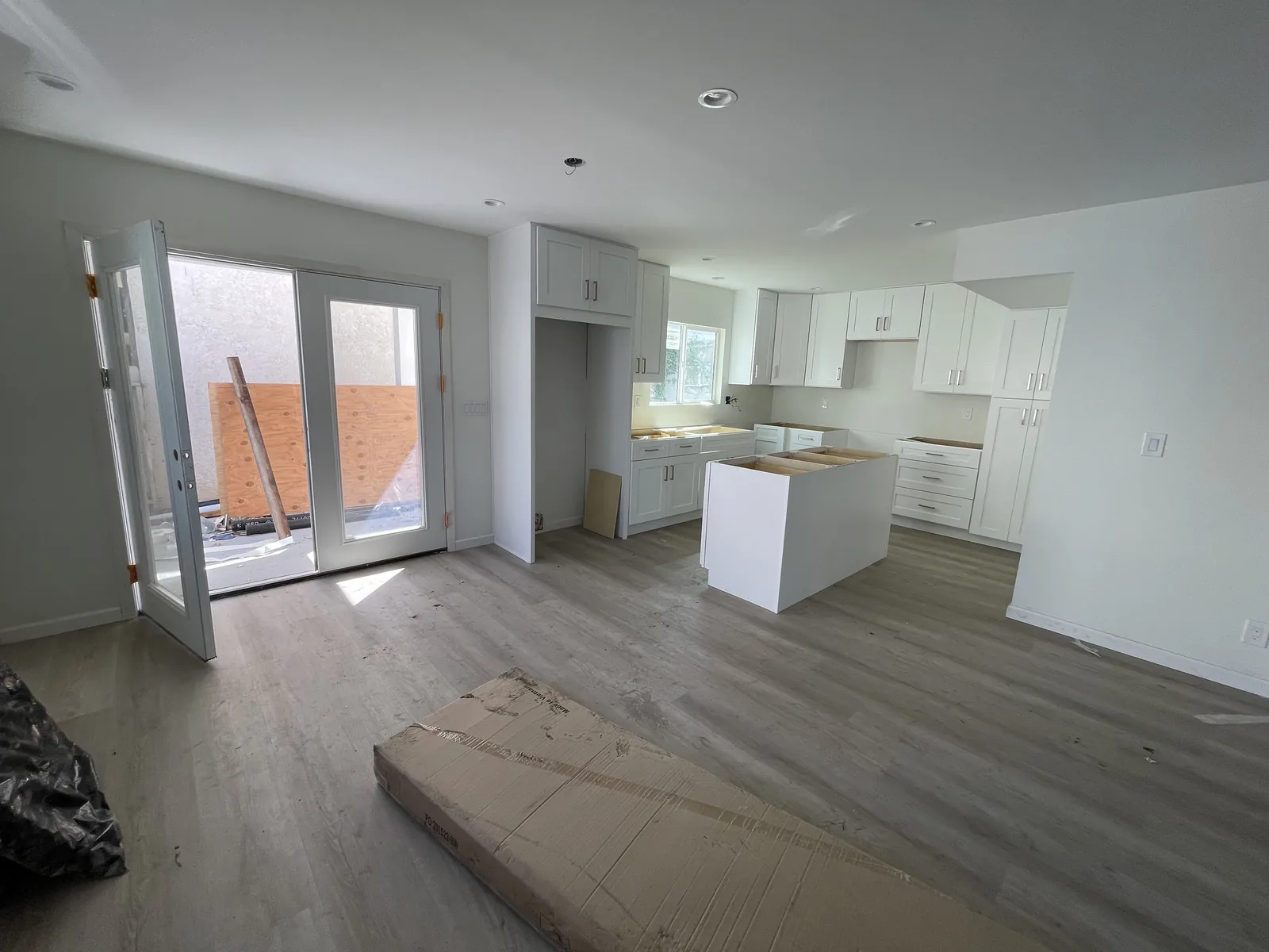 An open-concept kitchen and living area with a sliding glass door to a porch