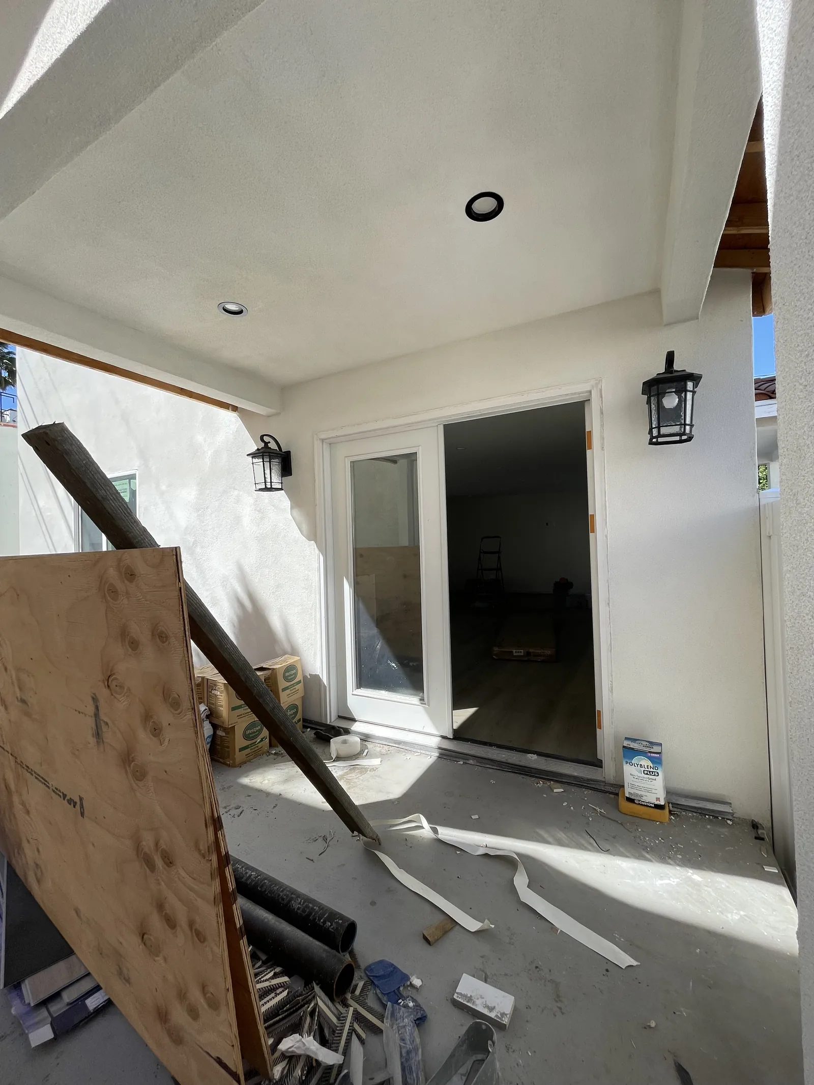 A small covered porch seen from outside through an open sliding door