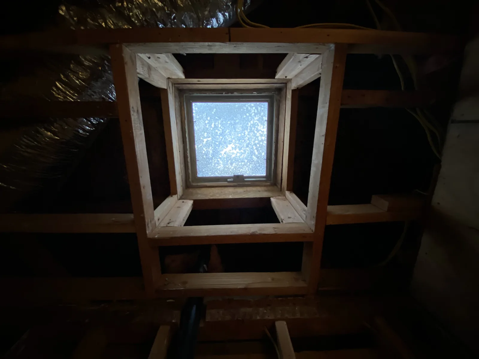 A new skylight framed into the attic above a bathroom