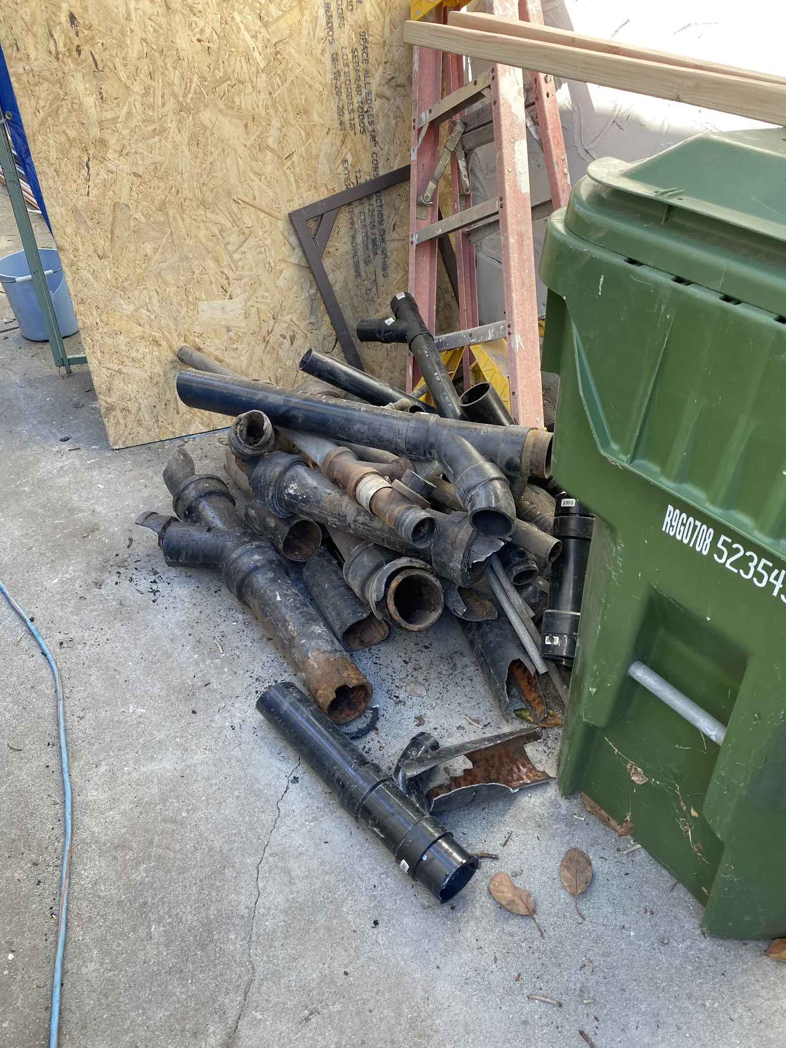 A pile of old rusted cast iron waste pipe removed from the house