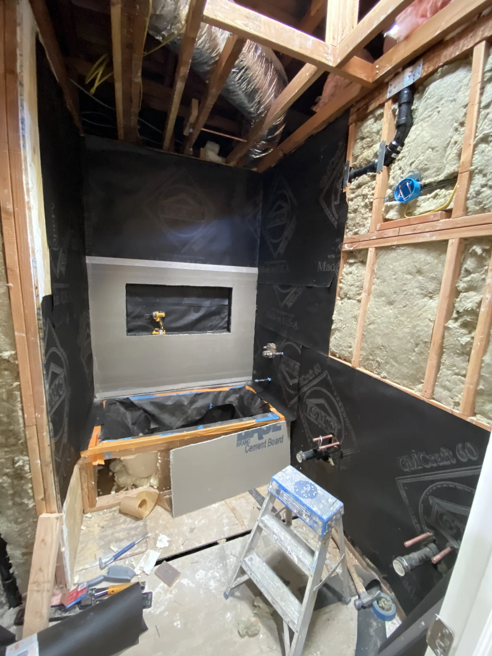 Cement board shower walls with a niche framed in, ready for waterproofing and tile