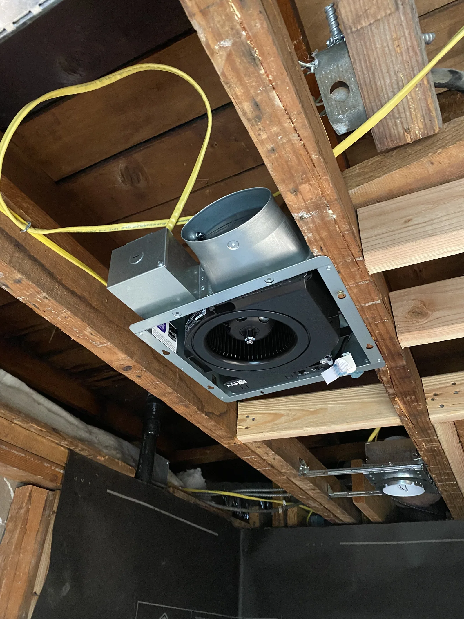 A new bathroom exhaust fan installed and wired in the attic