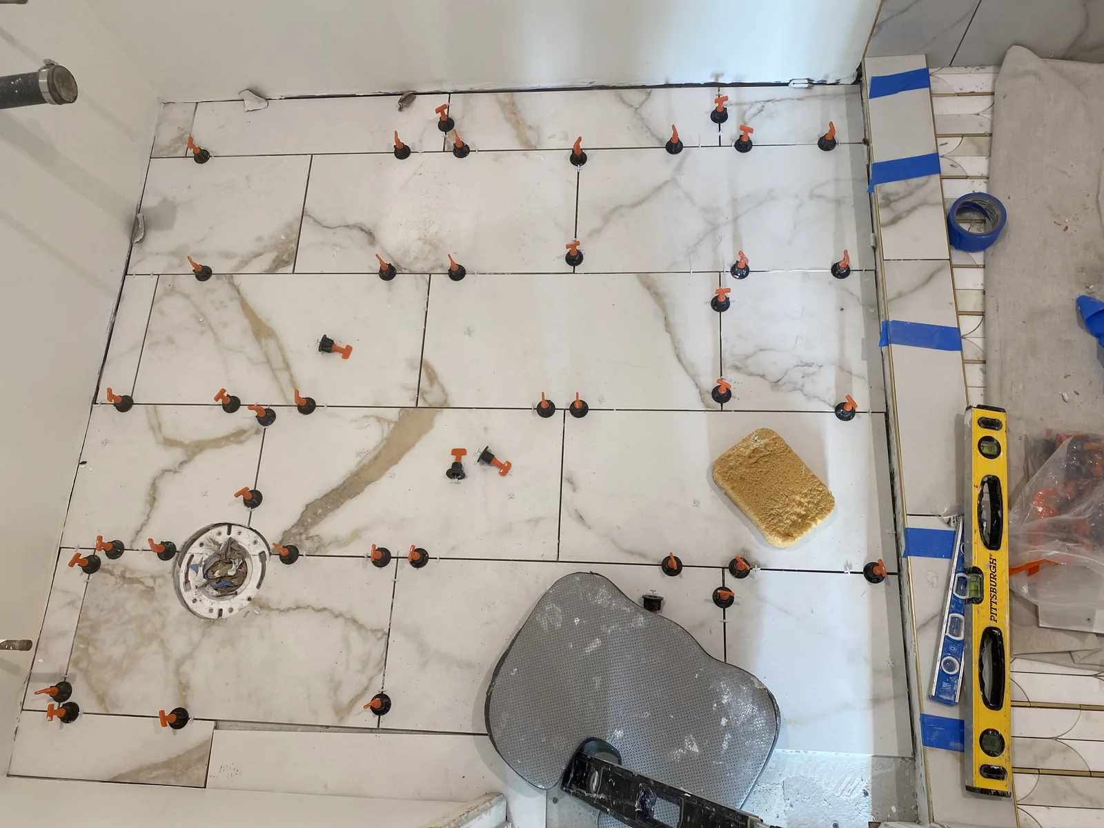 Finished floor tile with a toilet flange set in place