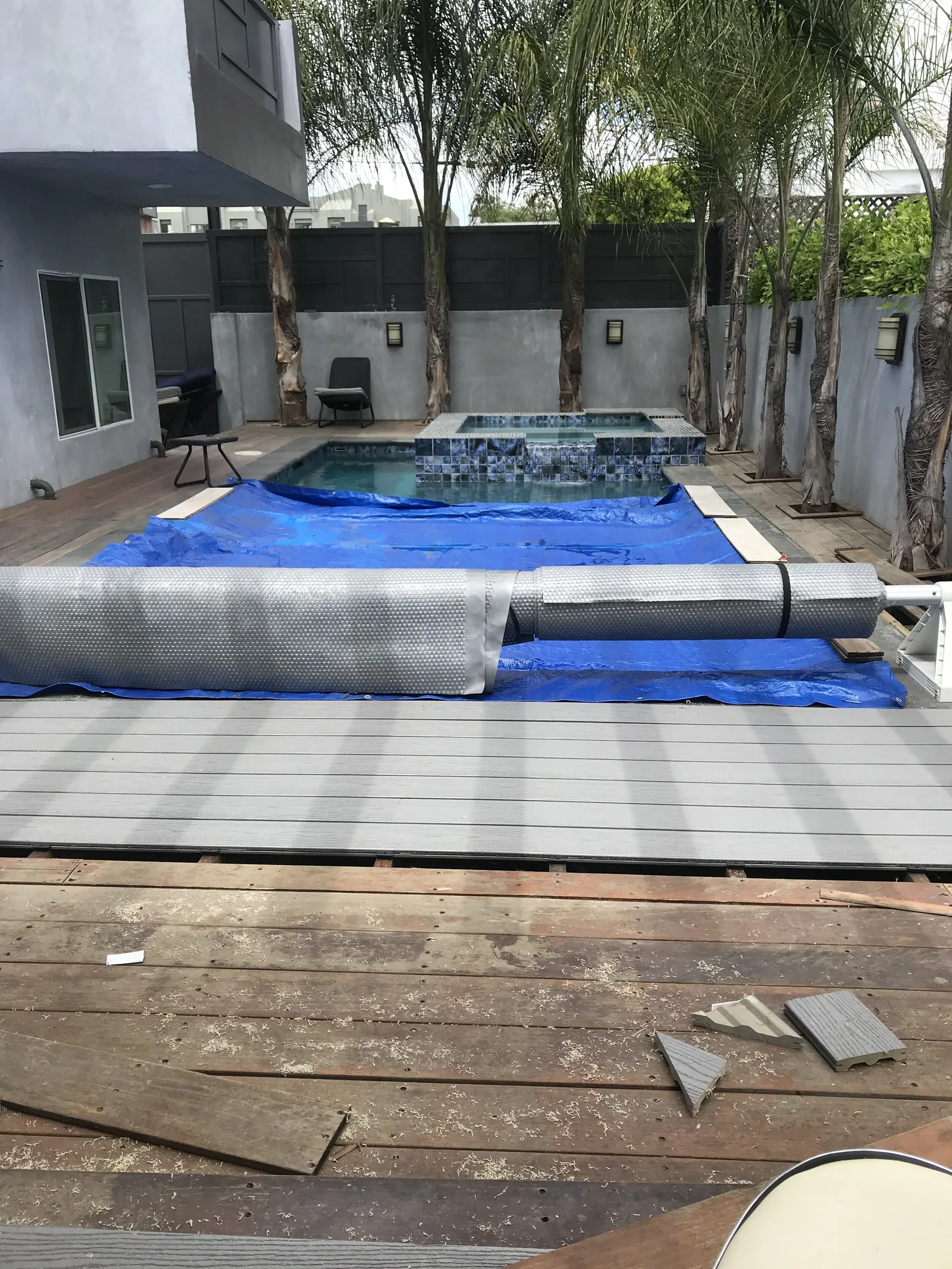 The old wood pool deck with the pool covered, before work began