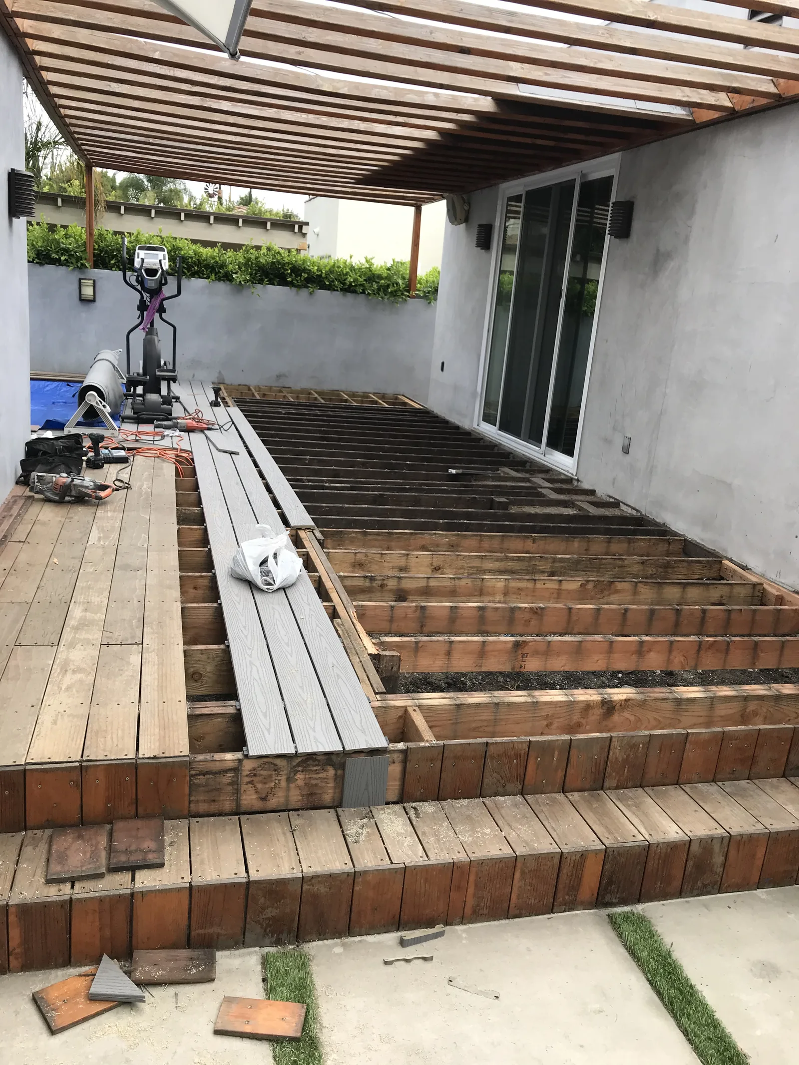 The old deck partly removed, with new joists exposed and Trex boards staged