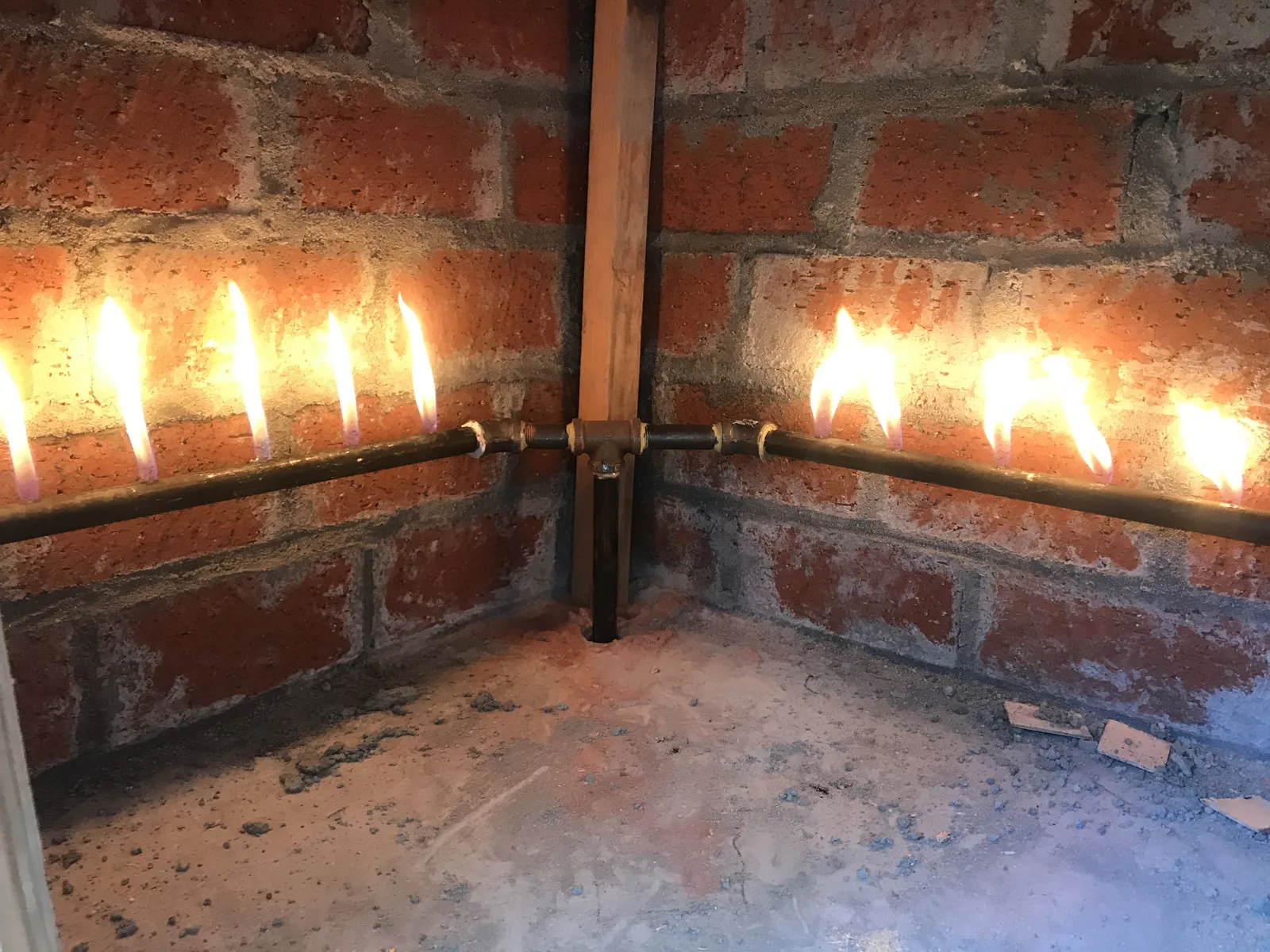 Custom-built burners lit inside a brick-lined oven cavity