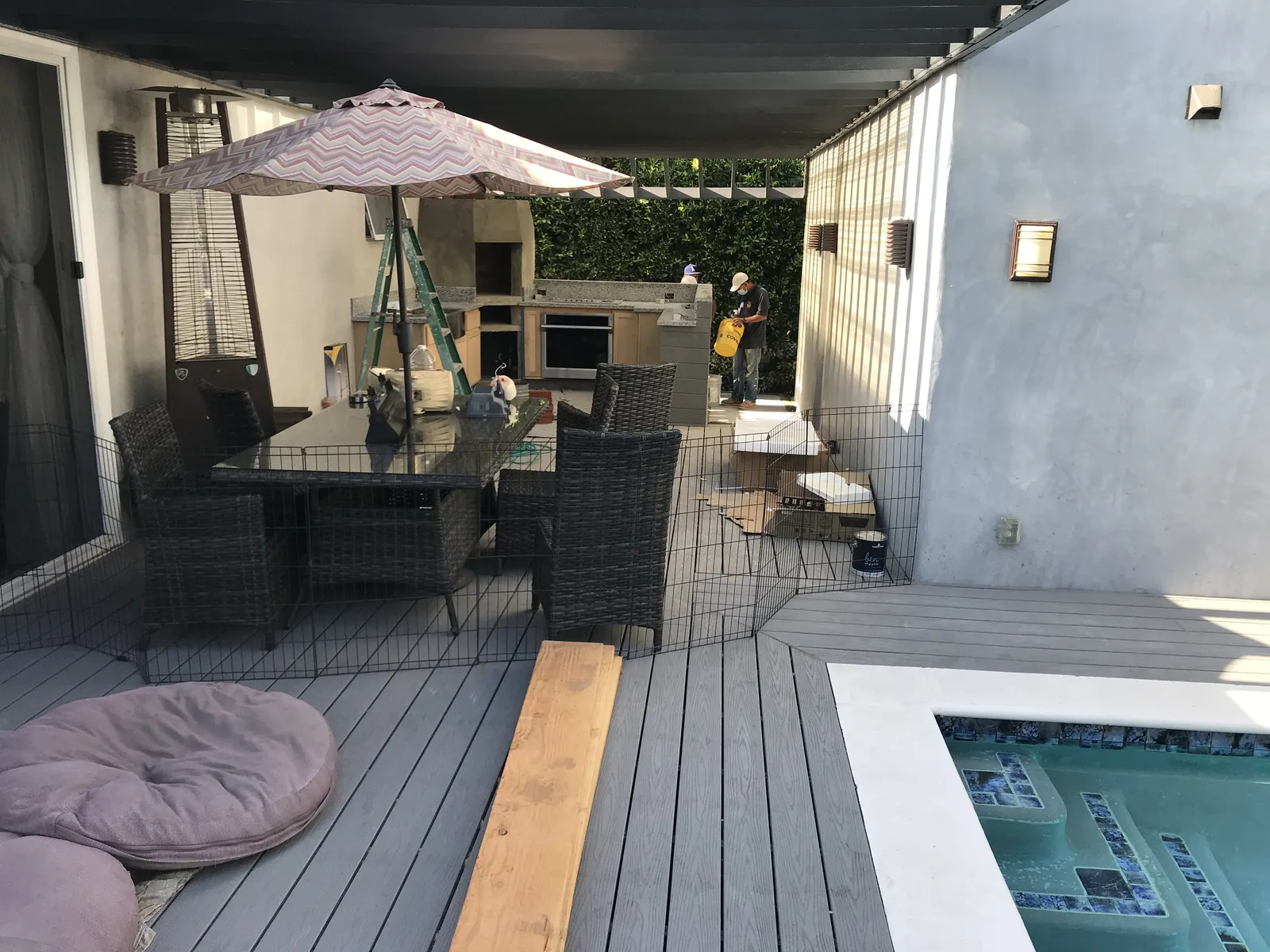 A wide view of a deck with river rock facing starting on an oven