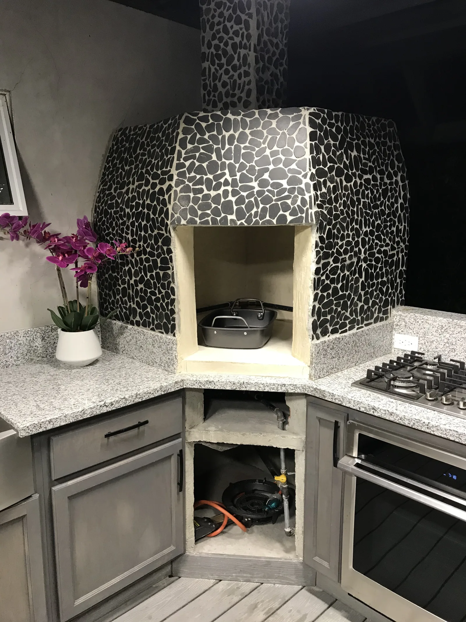 The finished clay oven with river rock facing
