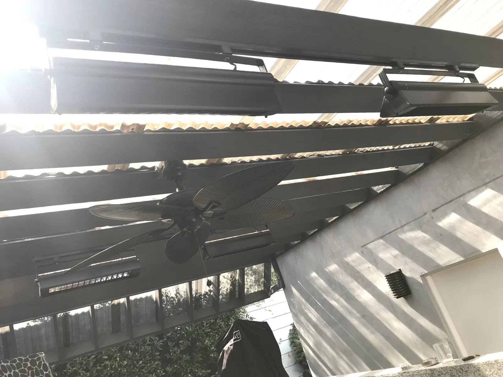 The finished pergola extension with a ceiling fan and heaters