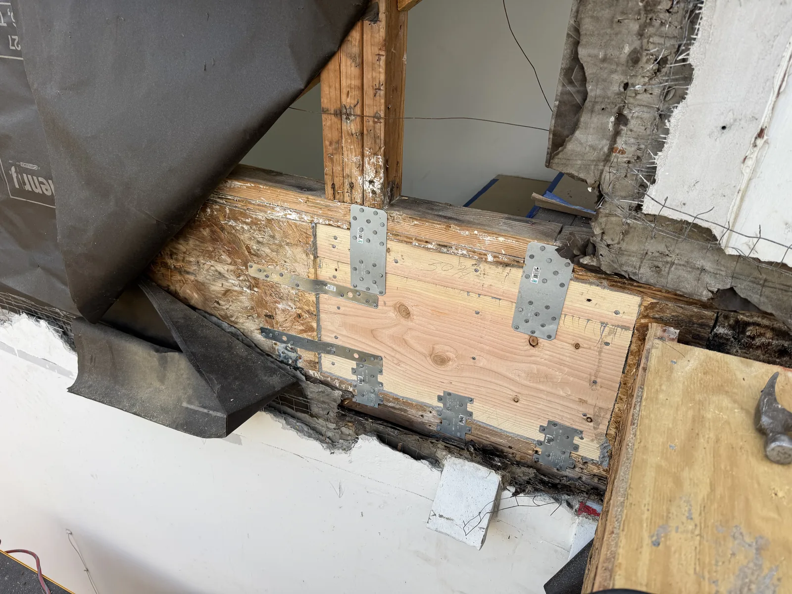 Another angle of the galvanized joist hardware reinforcing the new framing