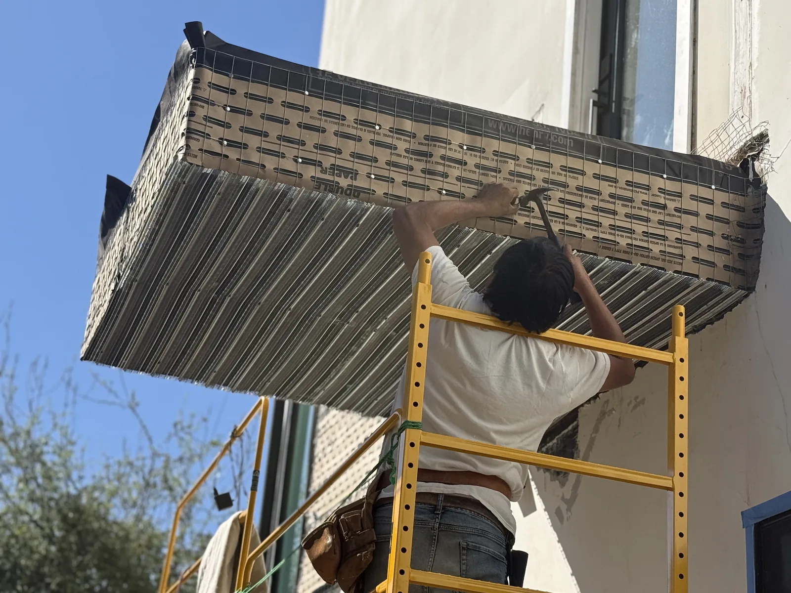 Gray waterproof coating applied to the underside of the rebuilt balcony
