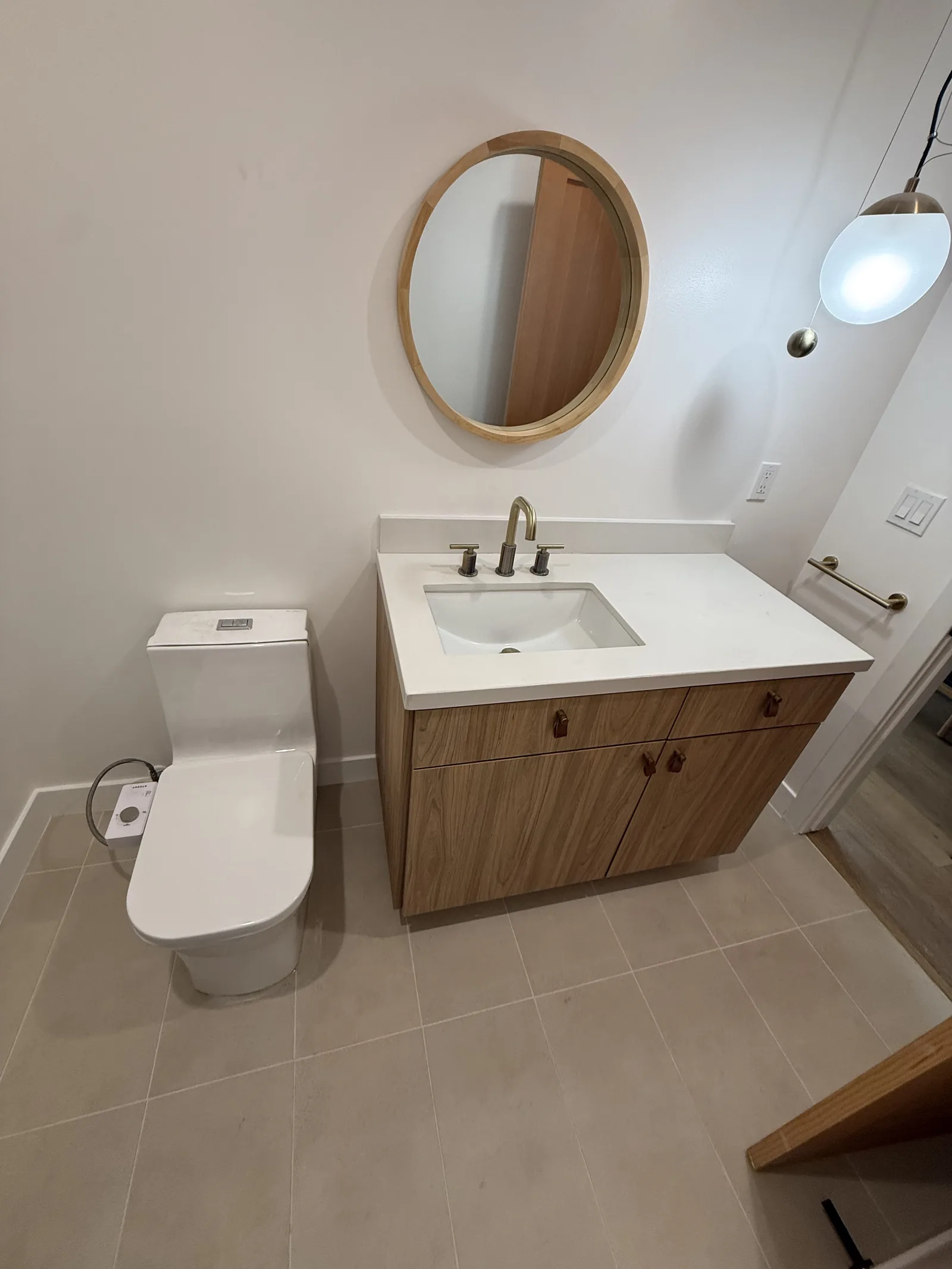 Another angle of the finished bathroom with vanity and mirror