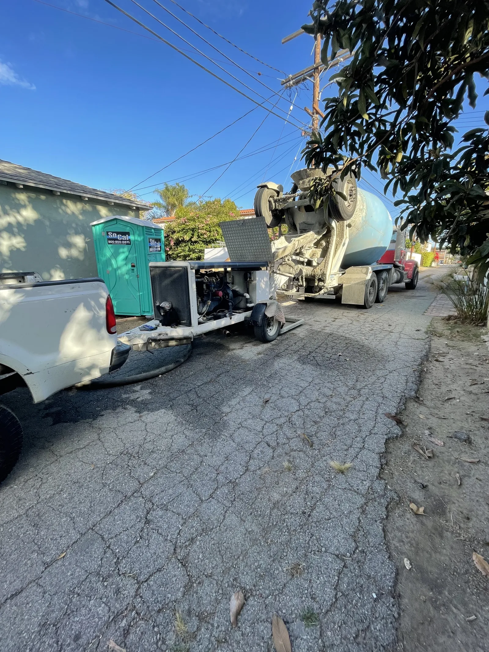 A concrete mixer truck and pump parked on the street