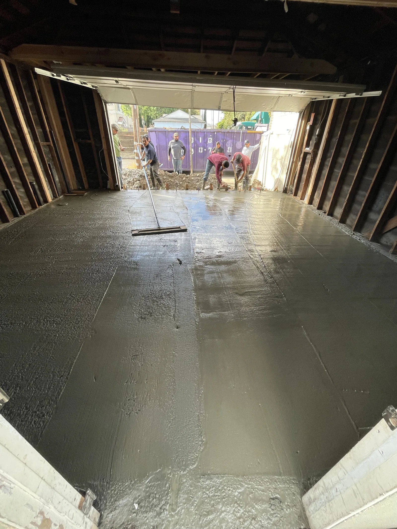 A freshly troweled concrete slab inside the garage