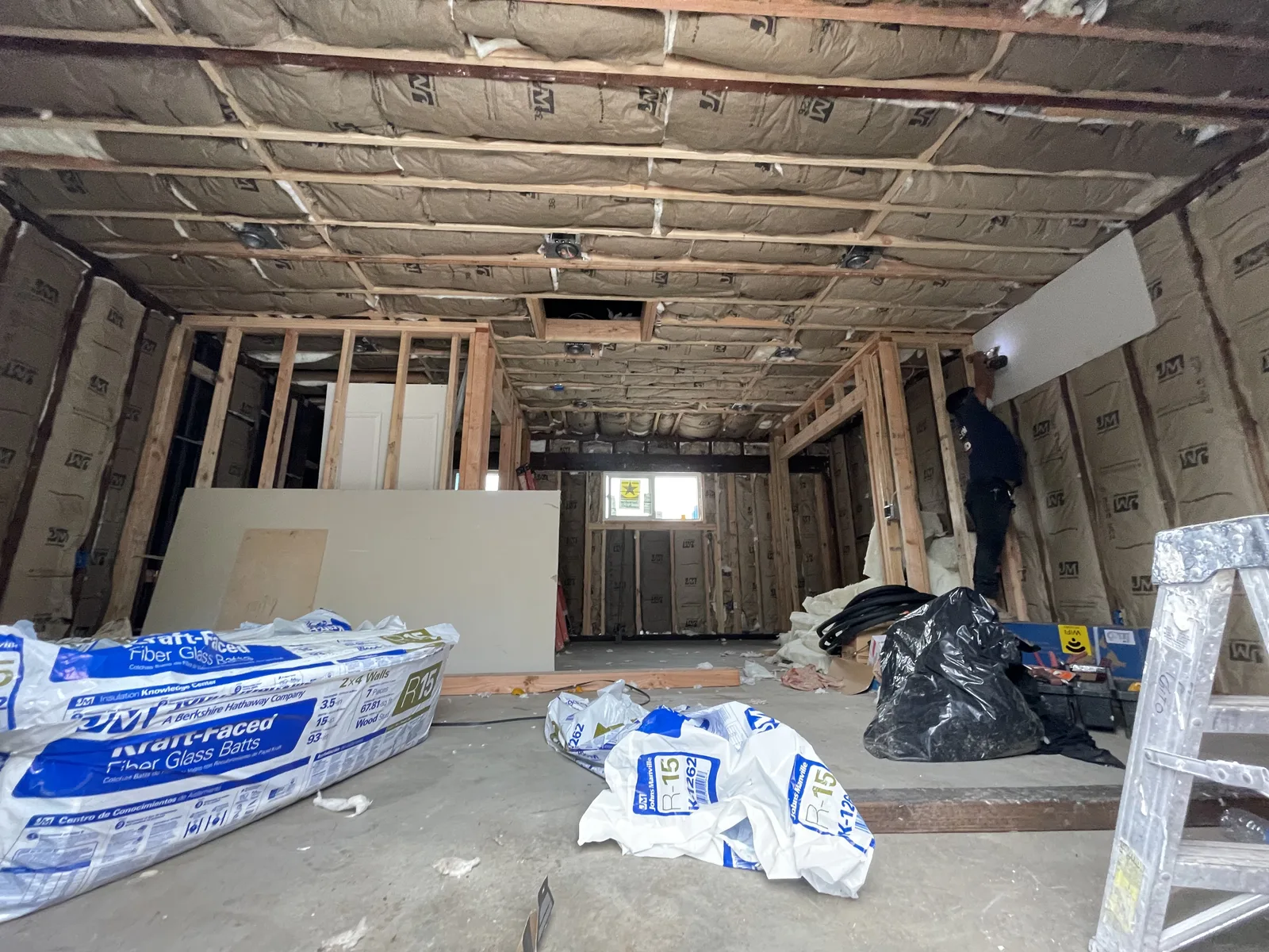 Ceiling insulation complete, looking down a framed hallway