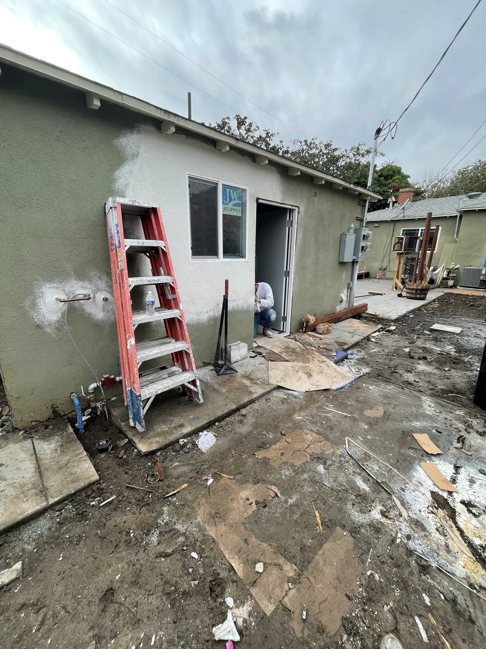 Finished exterior stucco with a new door entrance