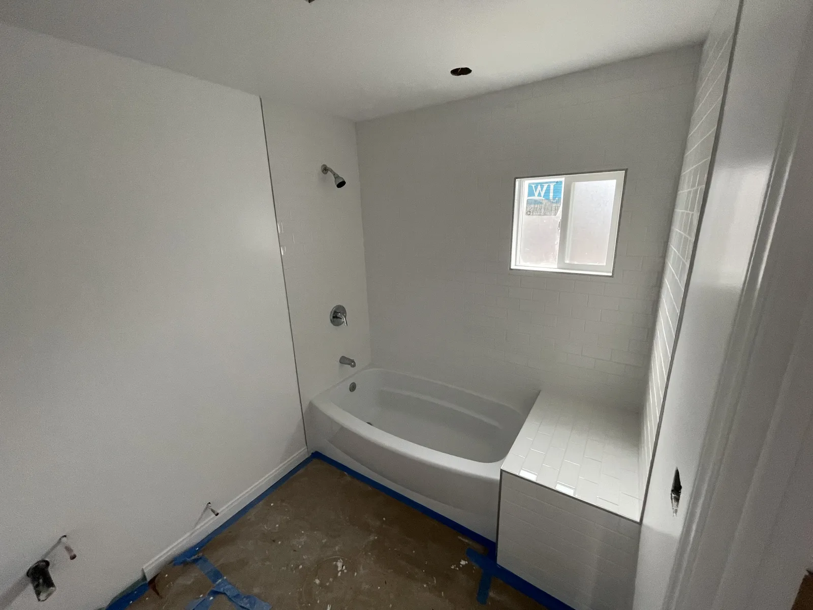 A finished bathtub with a tile surround