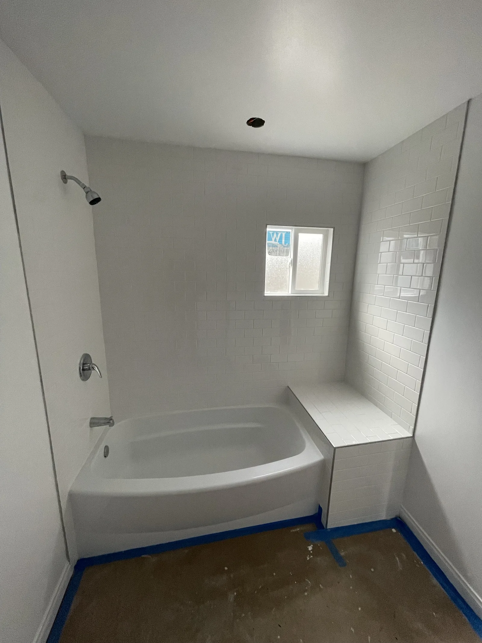 A finished bathtub and tile surround, viewed from a different angle