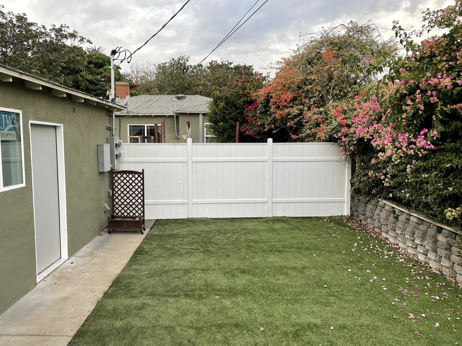 A dividing fence next to a building's side entrance