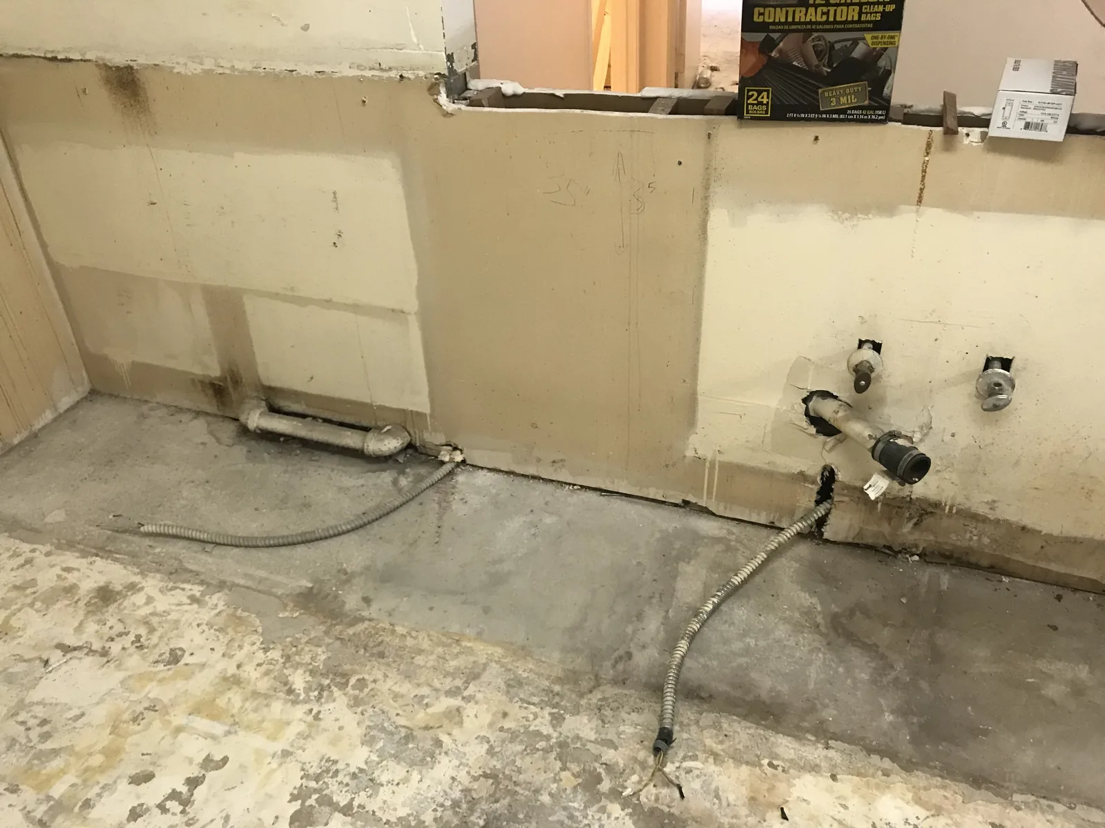 A bathroom wall opened down to bare studs during demolition