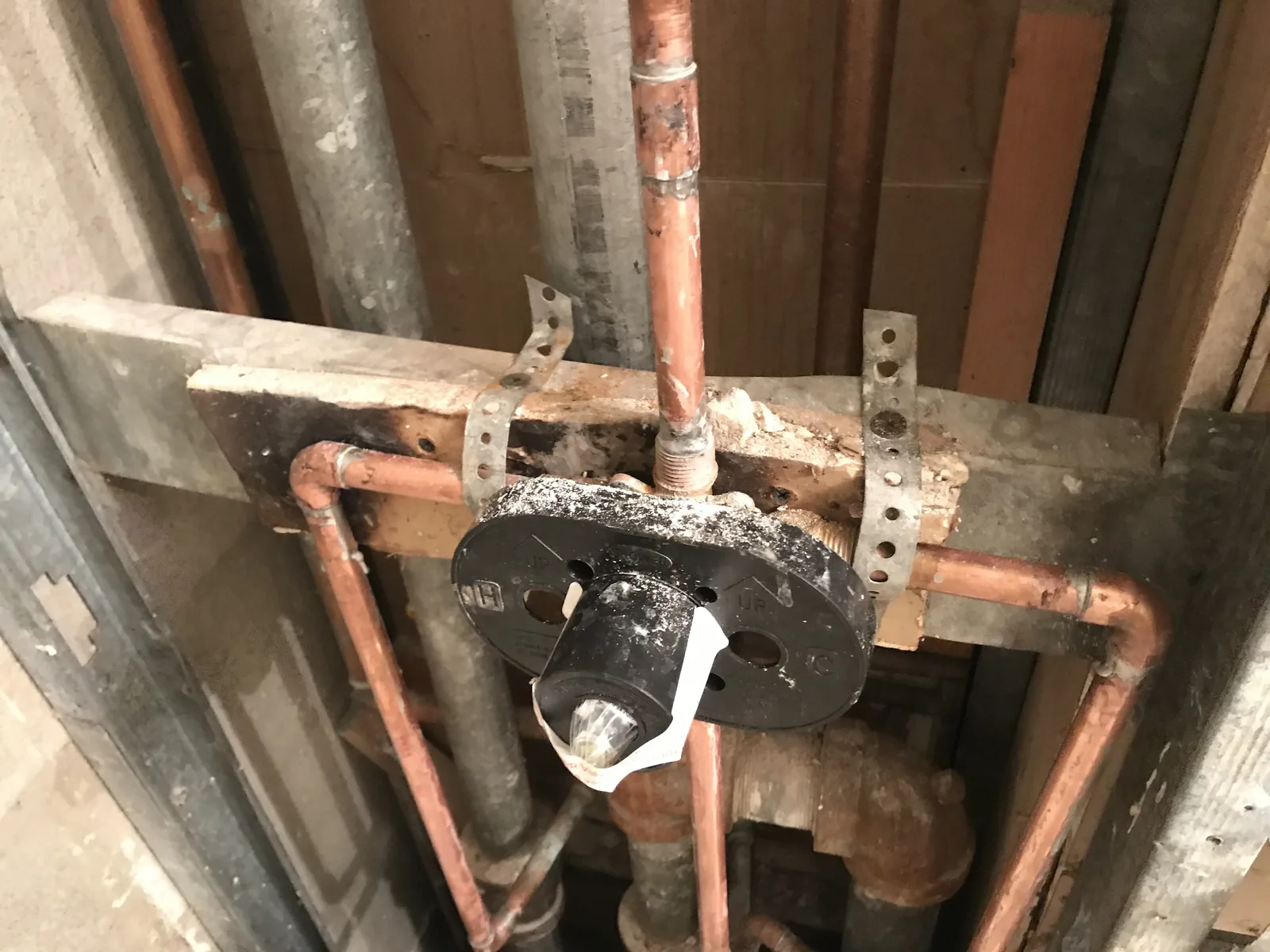 Copper supply lines roughed in overhead inside an open wall cavity