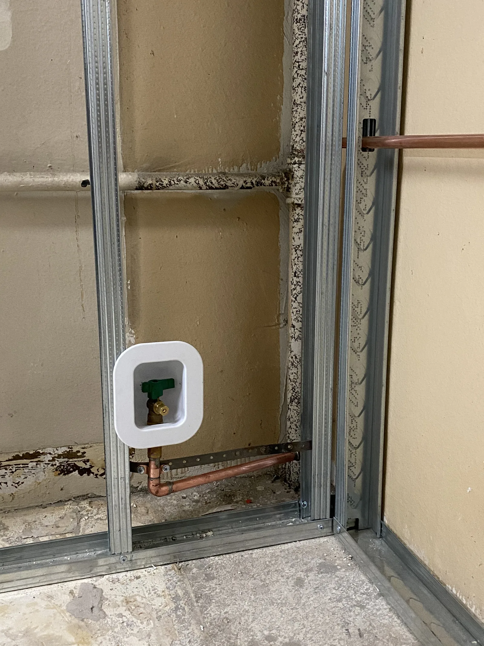 A recessed ice-maker water valve box plumbed into new wall framing