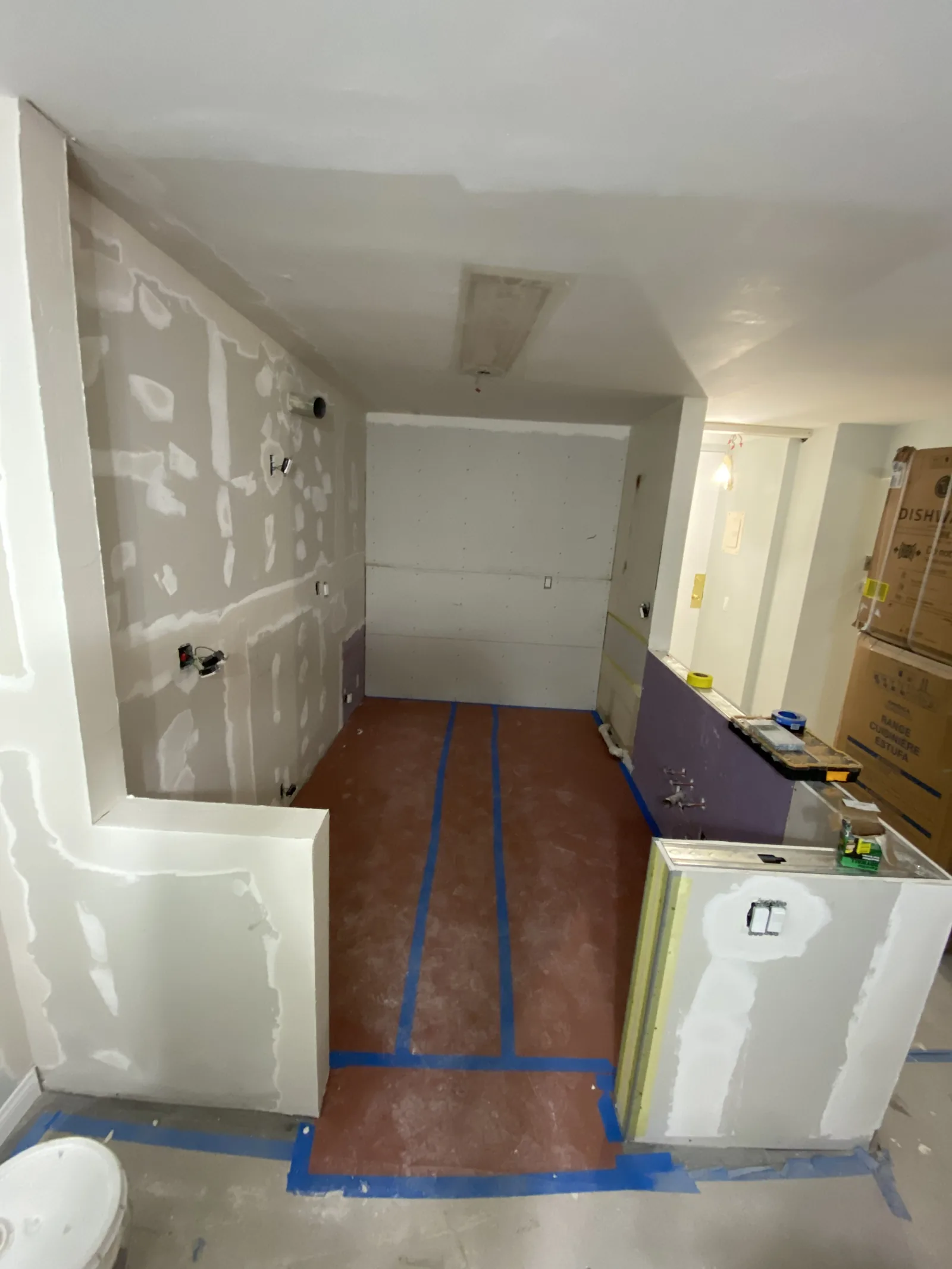Another angle of the kitchen peninsula framing with the hallway visible beyond
