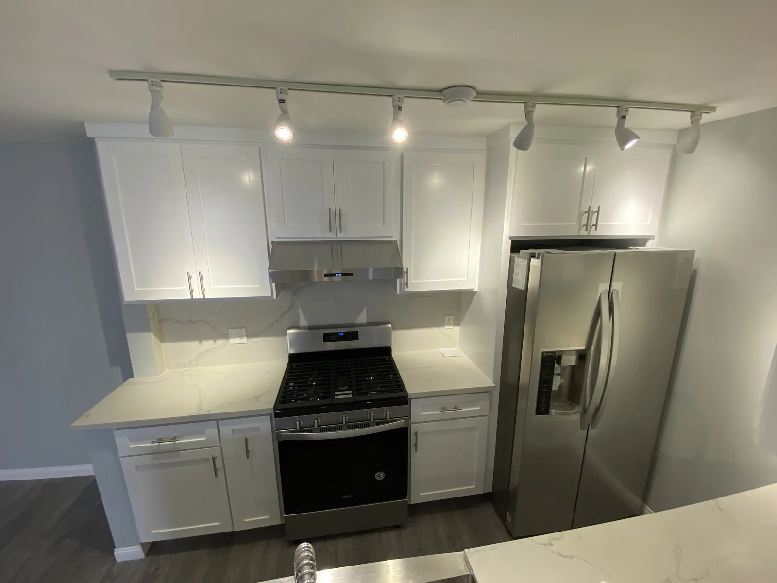 The finished kitchen range, hood, and refrigerator from another angle