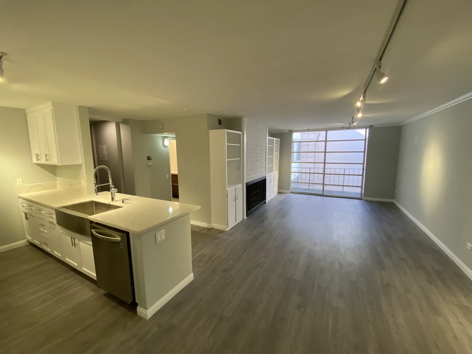 The finished kitchen island with the dishwasher, living area visible beyond