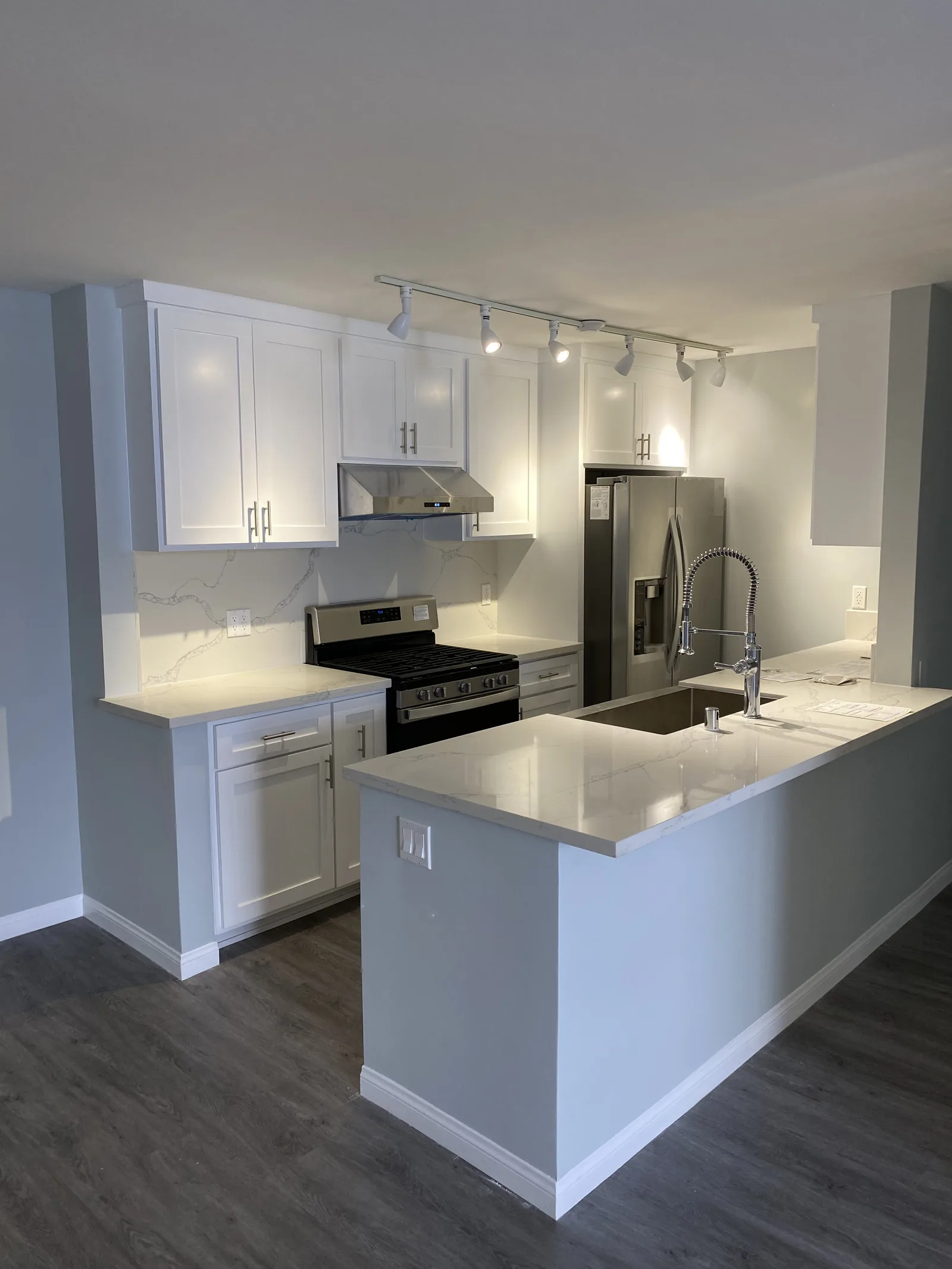 A wide view of the finished kitchen with natural light